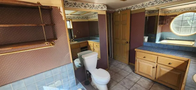 a bathroom with a toilet a sink and shower