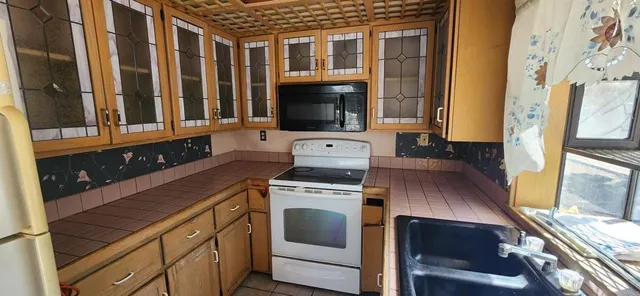 a kitchen with a stove and a sink