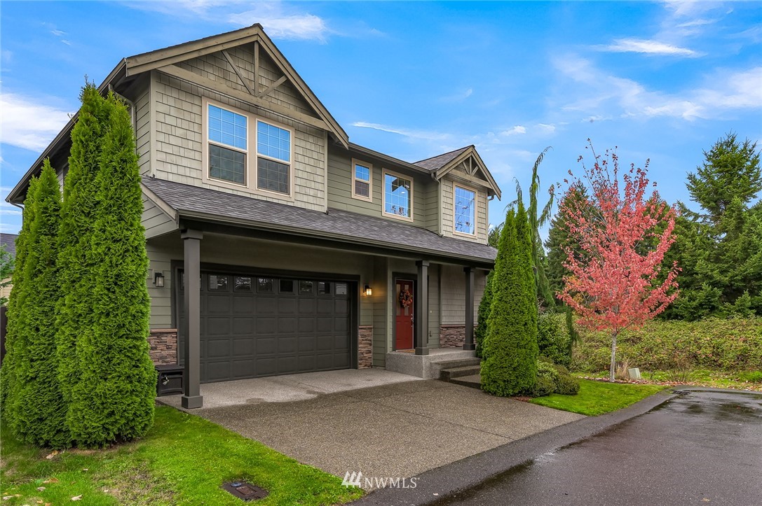 1017 Chelan Place Northeast Renton, WA 98059 - Photo 2 of 40 a front view of a house with a yard and garage
