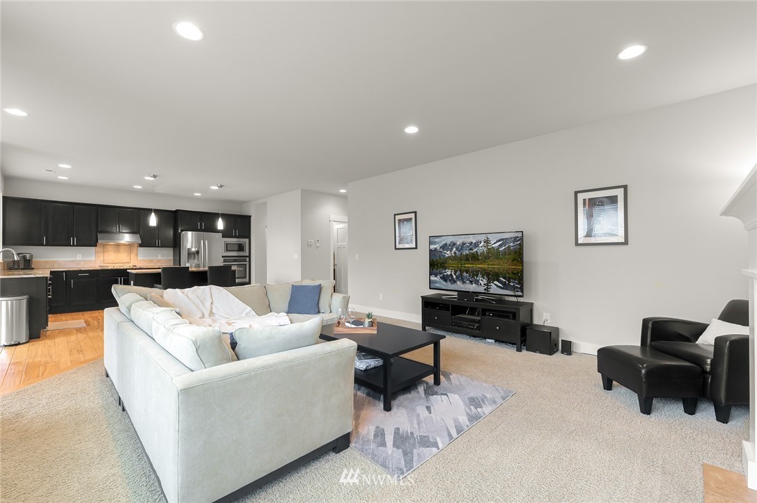 1017 Chelan Place Northeast Renton, WA 98059 - Photo 22 of 40 a living room with furniture and a flat screen tv