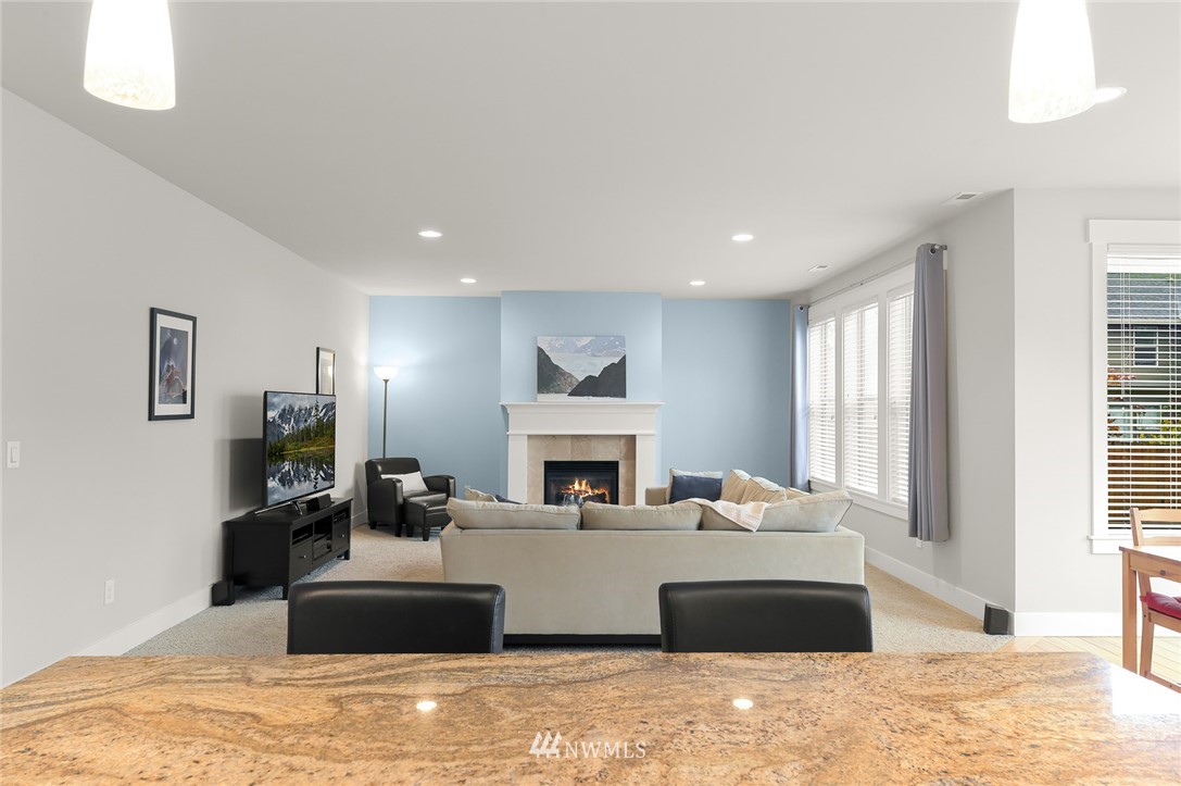 1017 Chelan Place Northeast Renton, WA 98059 - Photo 24 of 40 a living room with a couch fireplace and window