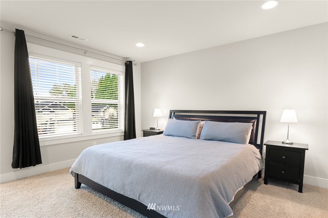 1017 Chelan Place Northeast Renton, WA 98059 - Photo 27 of 40 a bedroom with a bed and a night stand