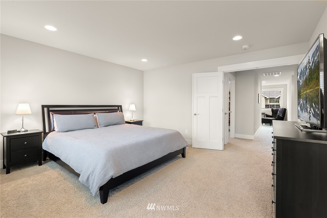 1017 Chelan Place Northeast Renton, WA 98059 - Photo 28 of 40 a spacious bedroom with a bed and a large mirror