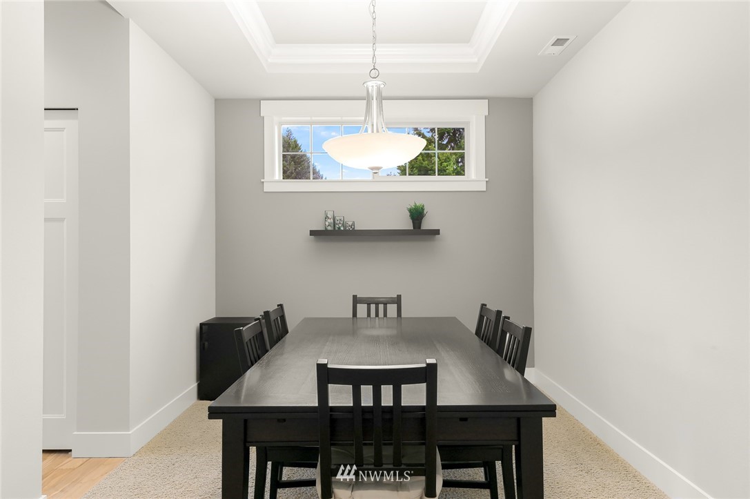 1017 Chelan Place Northeast Renton, WA 98059 - Photo 6 of 40 a view of a dining room with a table and chairs