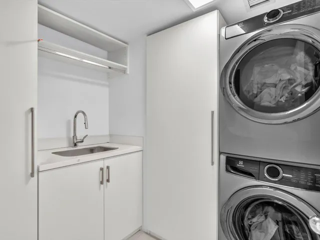 a living room with furniture kitchen view and a table