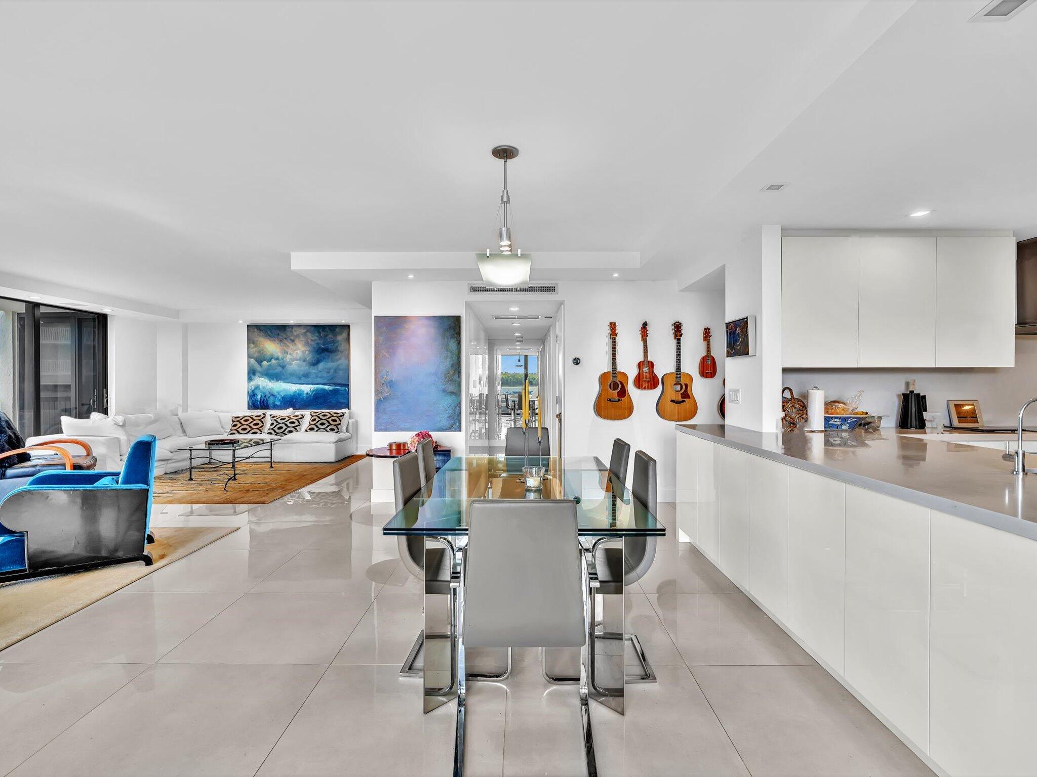 3300 South Ocean Boulevard, Unit 108S Palm Beach, FL 33480 - Photo 14 of 66 a view of a dining room and livingroom with furniture wooden floor a chandelier