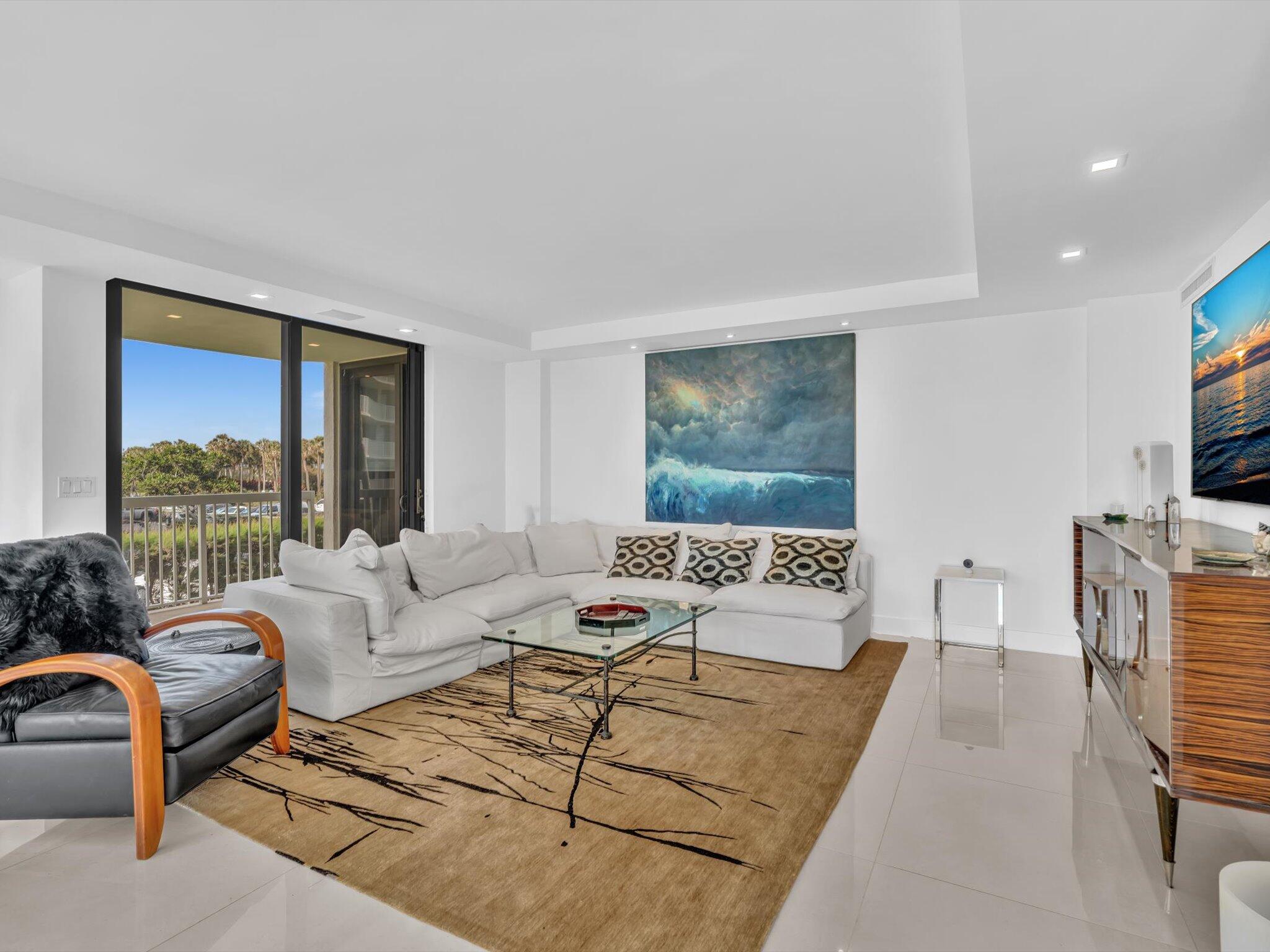 3300 South Ocean Boulevard, Unit 108S Palm Beach, FL 33480 - Photo 18 of 66 a living room with furniture and a flat screen tv