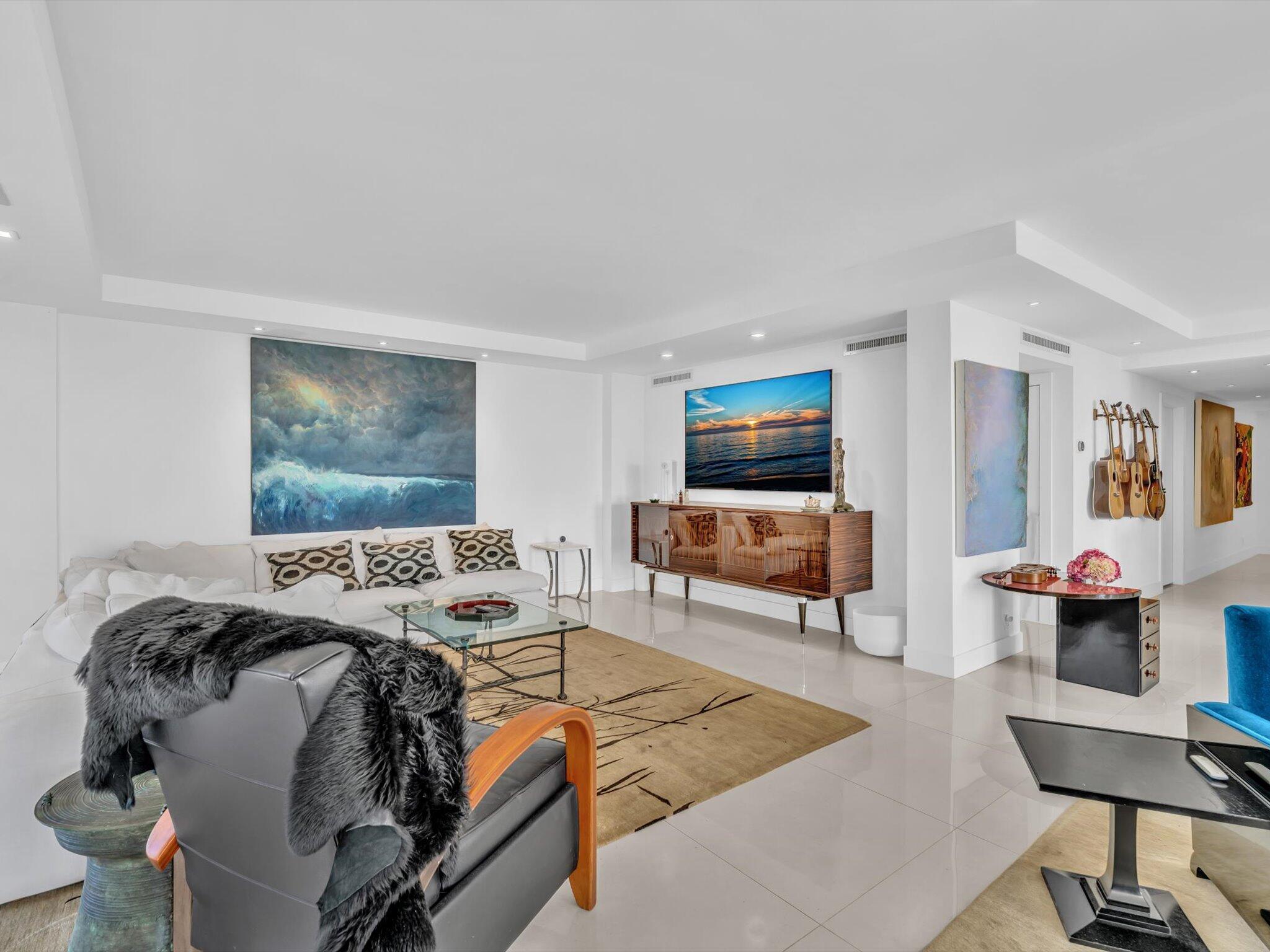 3300 South Ocean Boulevard, Unit 108S Palm Beach, FL 33480 - Photo 19 of 66 a bed room with furniture and a flat screen tv