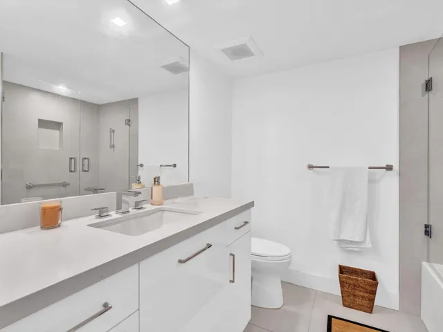 a bedroom with a bed and large windows