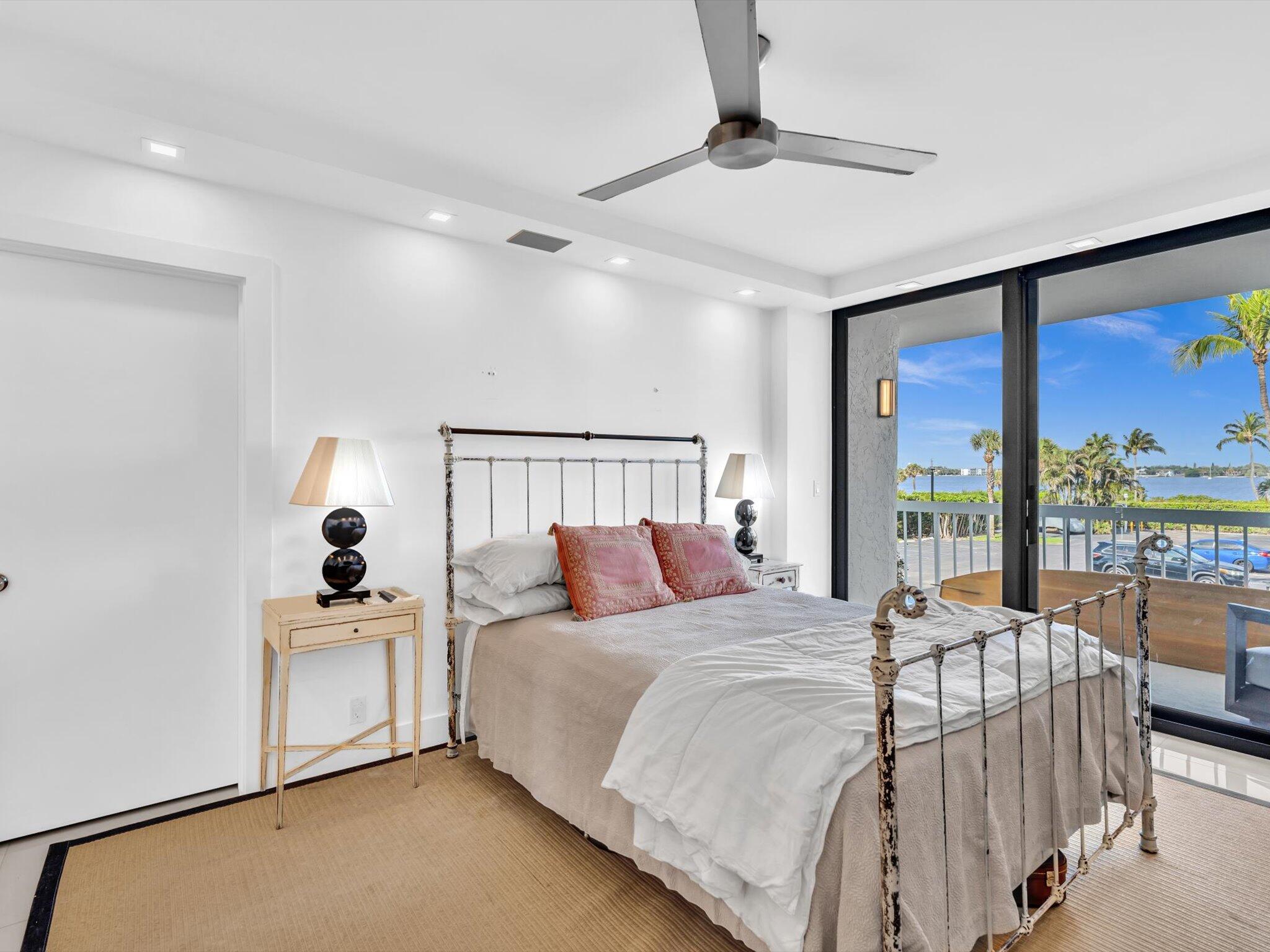 3300 South Ocean Boulevard, Unit 108S Palm Beach, FL 33480 - Photo 27 of 66 a bedroom with a large bed and a large window