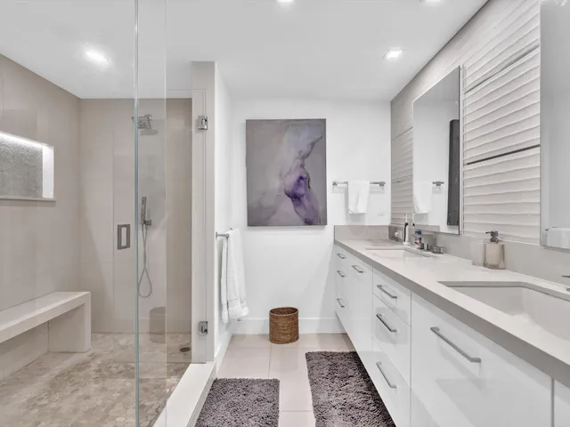 a roof deck with couches and potted plants