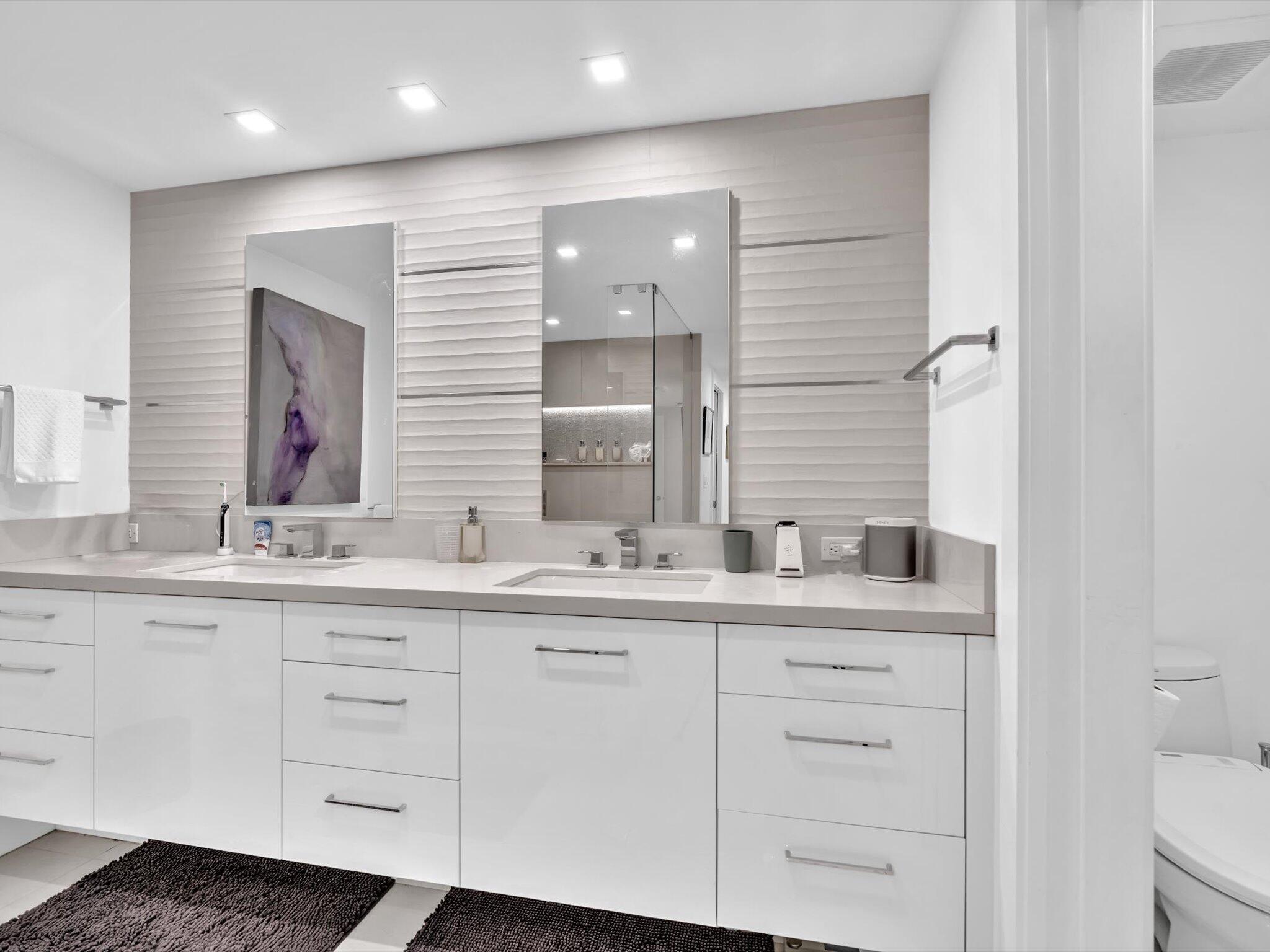 3300 South Ocean Boulevard, Unit 108S Palm Beach, FL 33480 - Photo 33 of 66 a bathroom with a double vanity sink and mirror