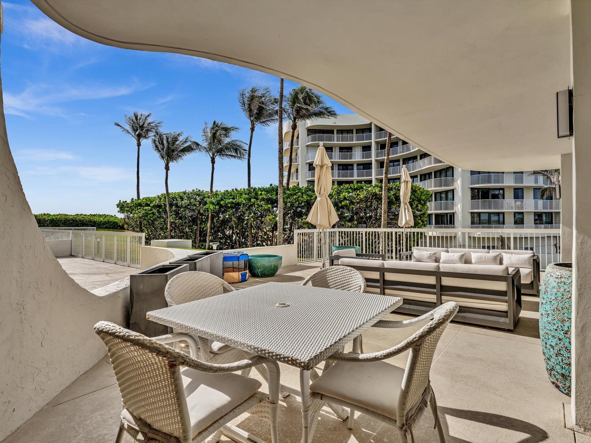 3300 South Ocean Boulevard, Unit 108S Palm Beach, FL 33480 - Photo 35 of 66 a view of a patio with couches table and chairs and potted plants