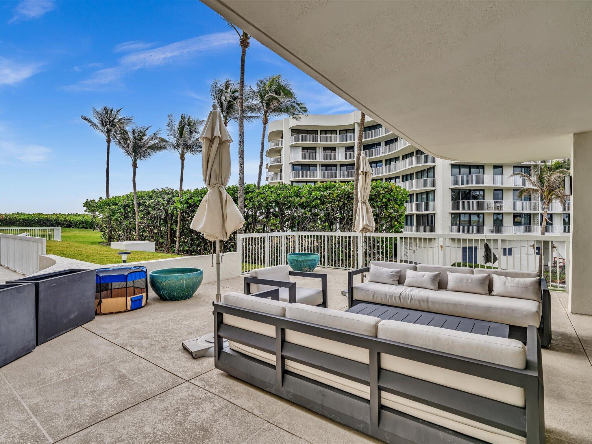 3300 South Ocean Boulevard, Unit 108S Palm Beach, FL 33480 - Photo 36 of 66 a roof deck with couches and potted plants