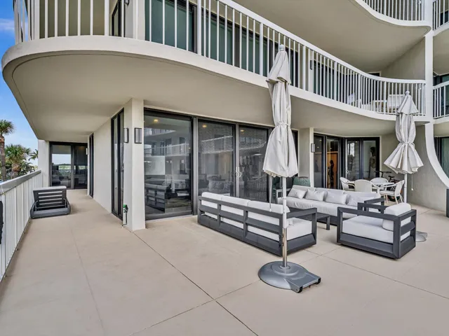 a balcony with furniture and a potted plant