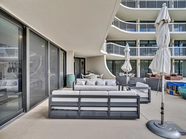a balcony with furniture and potted plants