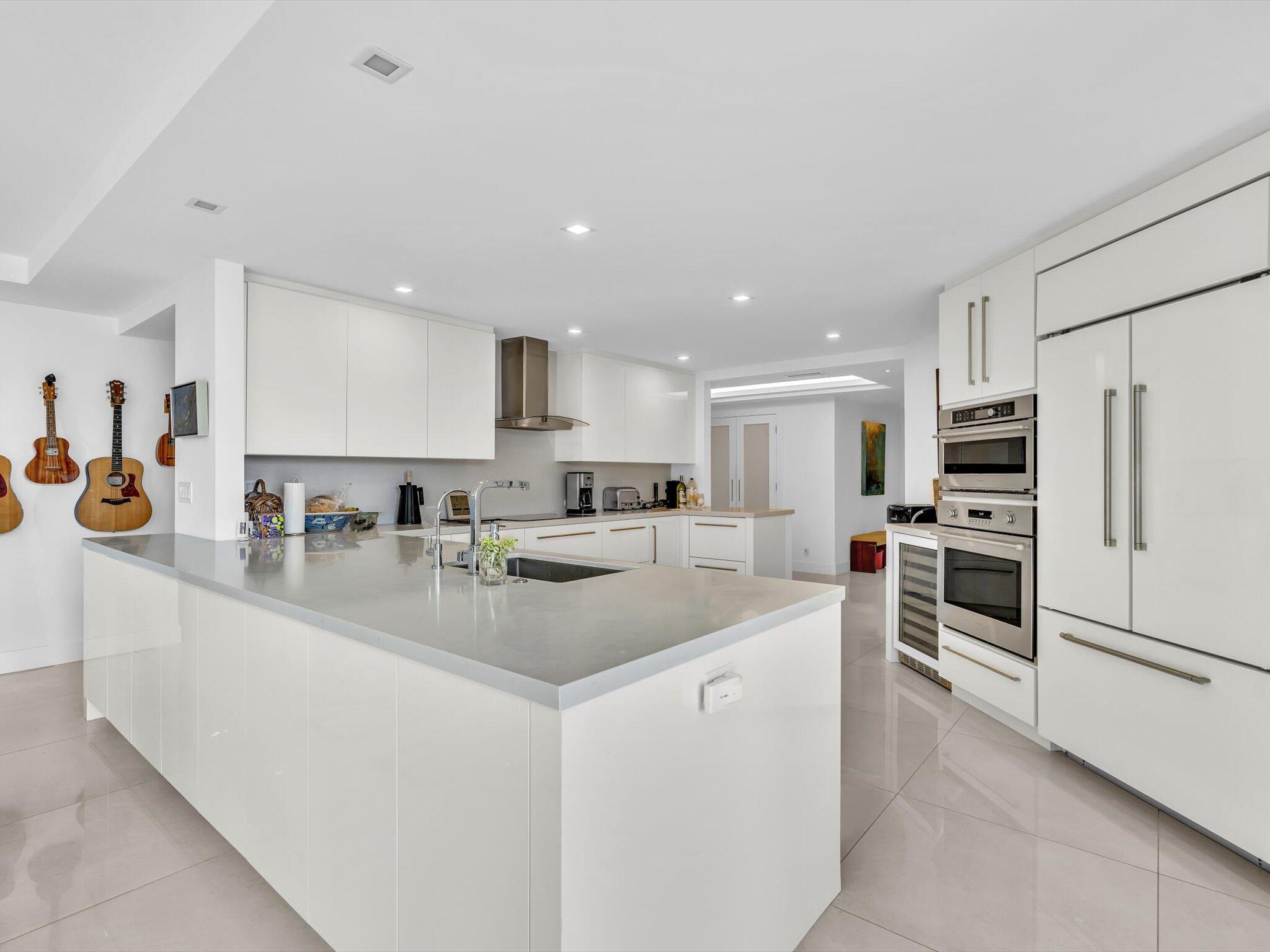 3300 South Ocean Boulevard, Unit 108S Palm Beach, FL 33480 - Photo 8 of 66 a kitchen with stainless steel appliances granite countertop a sink stove and refrigerator