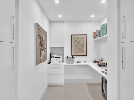 a view of a dining room and livingroom with furniture wooden floor a chandelier