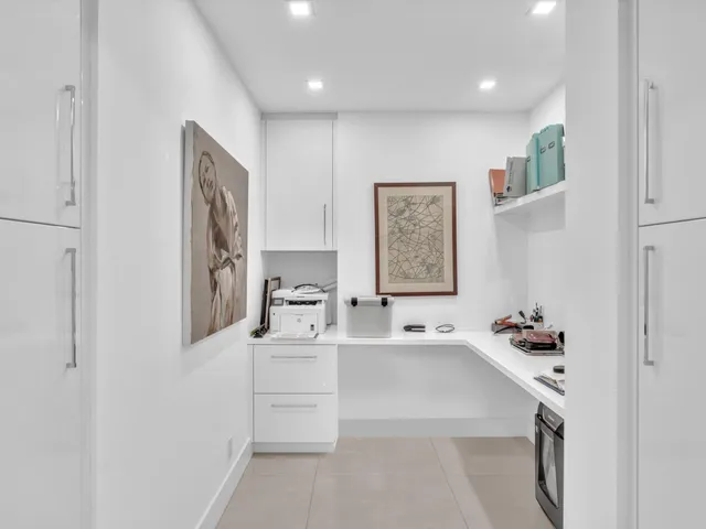 a view of a dining room and livingroom with furniture wooden floor a chandelier
