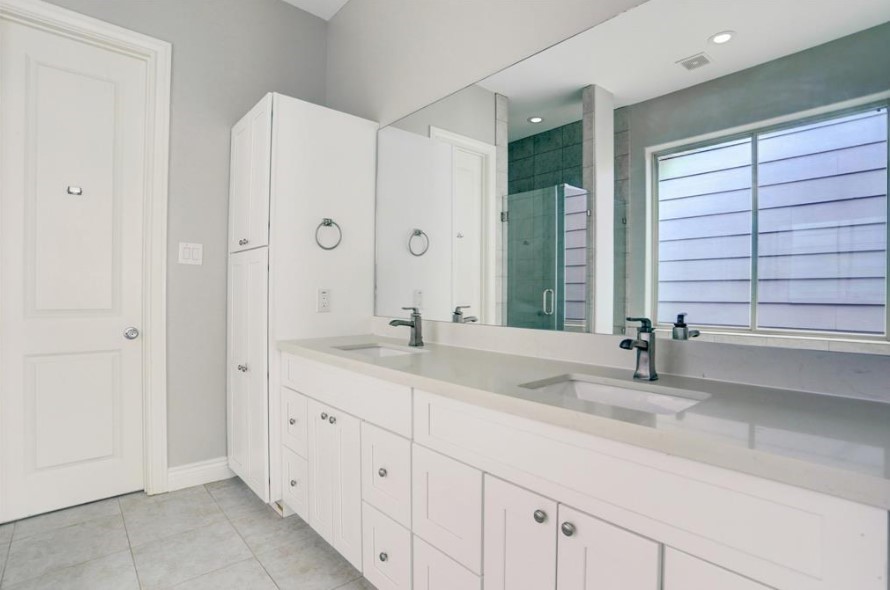 8907 Spring Knoll Forest Drive Houston, TX 77080 - Photo 12 of 21 a bathroom with double sink and a large mirror