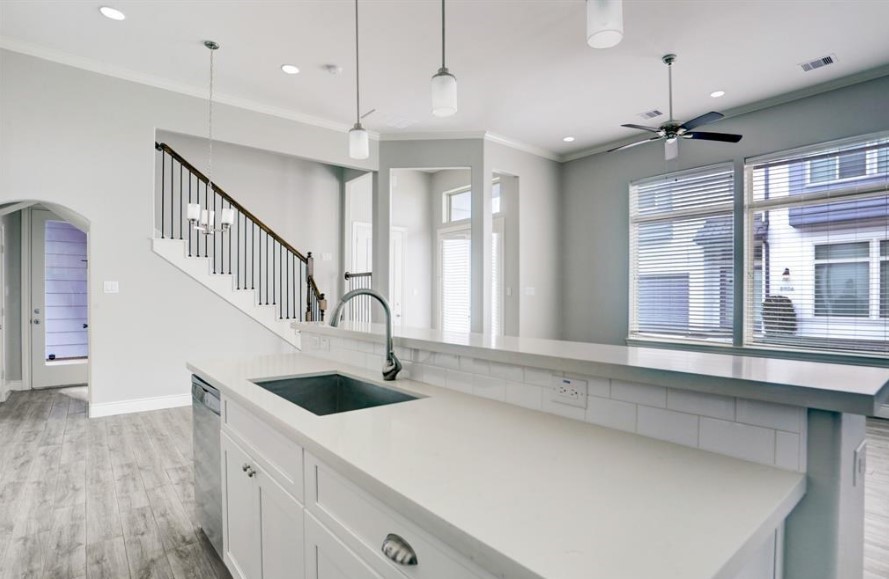 8907 Spring Knoll Forest Drive Houston, TX 77080 - Photo 7 of 21 a kitchen with stainless steel appliances a sink a stove and a window