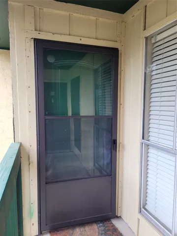 a utility room with wooden floor washer and dryer