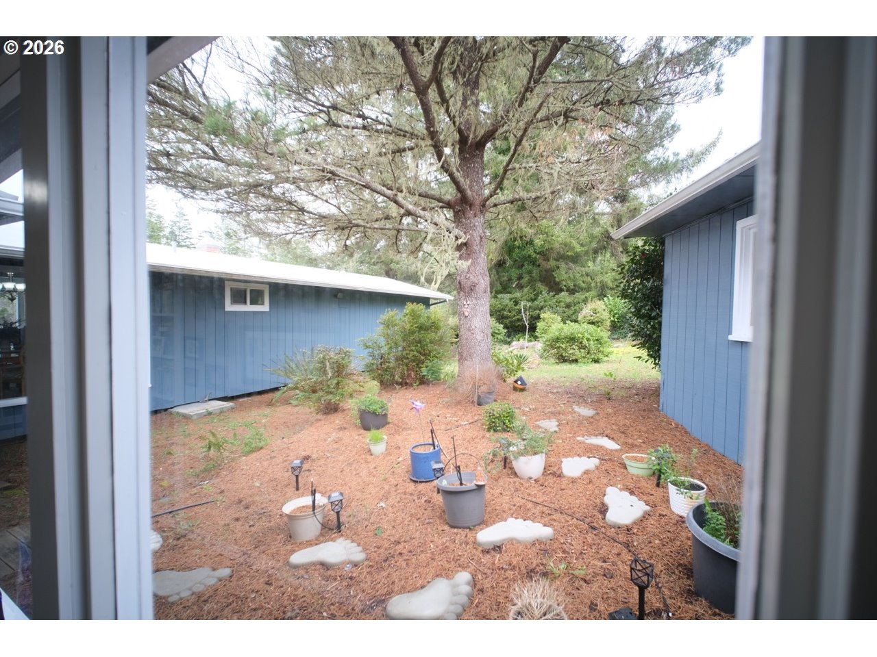 70214 Lakewood Road North Bend, OR 97459 - Photo 29 of 39 a view of a small yard with a tree