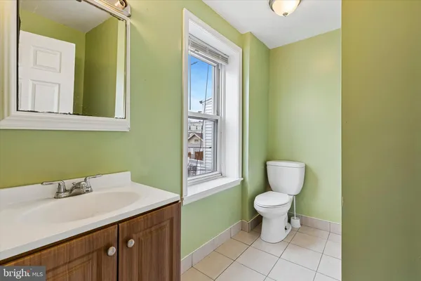 a white toilet sitting next to a shower curtain