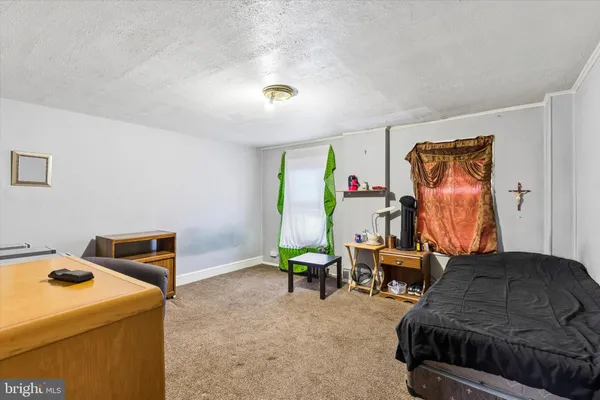 a living room with furniture a flat screen tv and a window