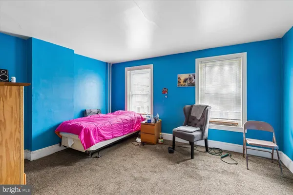 a bedroom with a bed and a desk