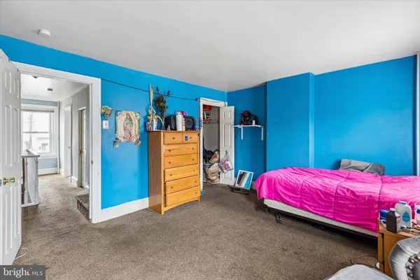 a bedroom with a bed and a dresser