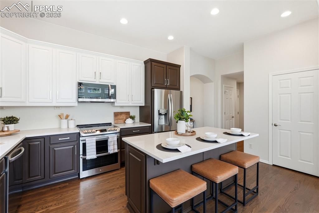 10744 Rhinestone Drive Colorado Springs, CO 80908 - Photo 16 of 50 a open kitchen with stainless steel appliances kitchen island granite countertop a sink and cabinets