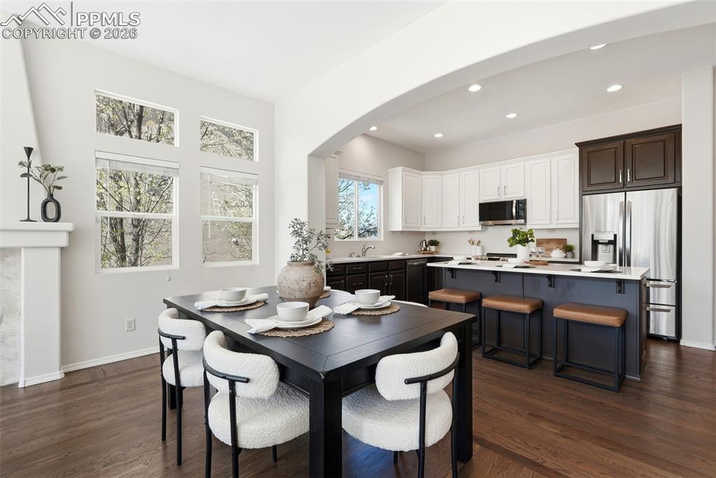 10744 Rhinestone Drive Colorado Springs, CO 80908 - Photo 18 of 50 a kitchen with a dining table chairs and refrigerator