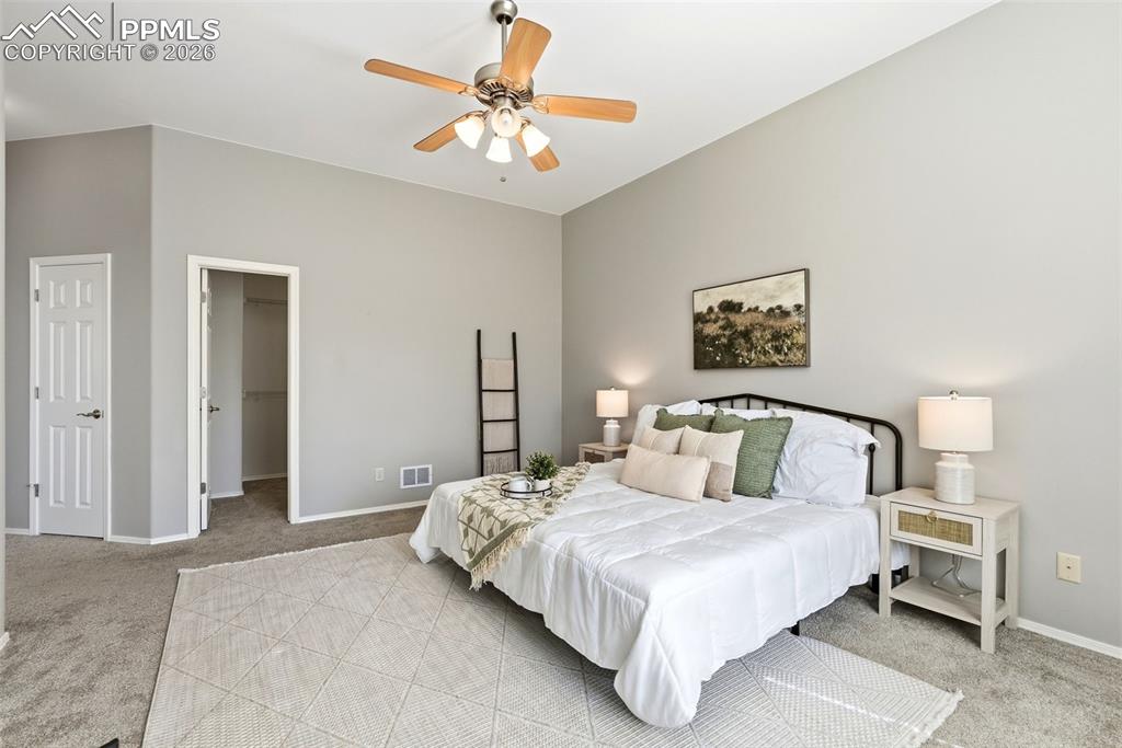 10744 Rhinestone Drive Colorado Springs, CO 80908 - Photo 21 of 50 a bedroom with a bed and a chandelier