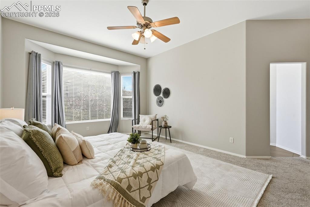 10744 Rhinestone Drive Colorado Springs, CO 80908 - Photo 22 of 50 a bedroom with a bed and a chandelier