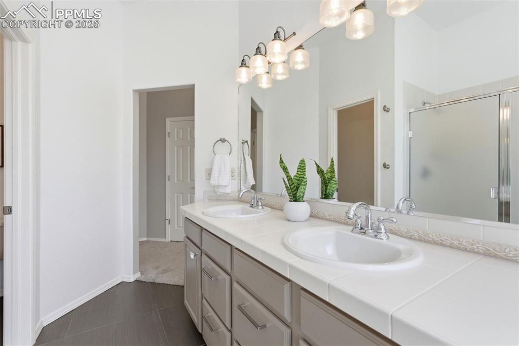 10744 Rhinestone Drive Colorado Springs, CO 80908 - Photo 26 of 50 a bathroom with a sink and a mirror
