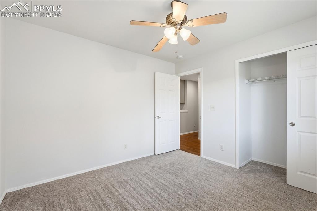 10744 Rhinestone Drive Colorado Springs, CO 80908 - Photo 28 of 50 an empty room with a ceiling fan and a window