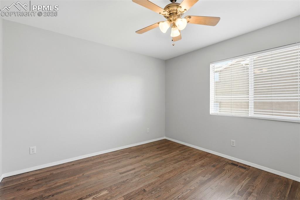 10744 Rhinestone Drive Colorado Springs, CO 80908 - Photo 29 of 50 wooden floor in an empty room with a window