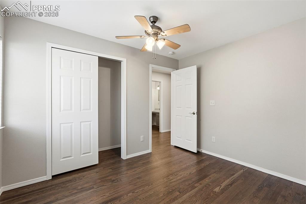 10744 Rhinestone Drive Colorado Springs, CO 80908 - Photo 30 of 50 an empty room with wooden floor and ceiling fan