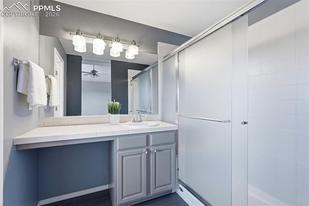 10744 Rhinestone Drive Colorado Springs, CO 80908 - Photo 36 of 50 a bathroom with a sink and a mirror