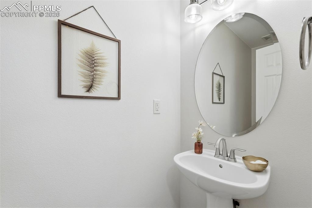10744 Rhinestone Drive Colorado Springs, CO 80908 - Photo 38 of 50 a bathroom with a sink and mirror