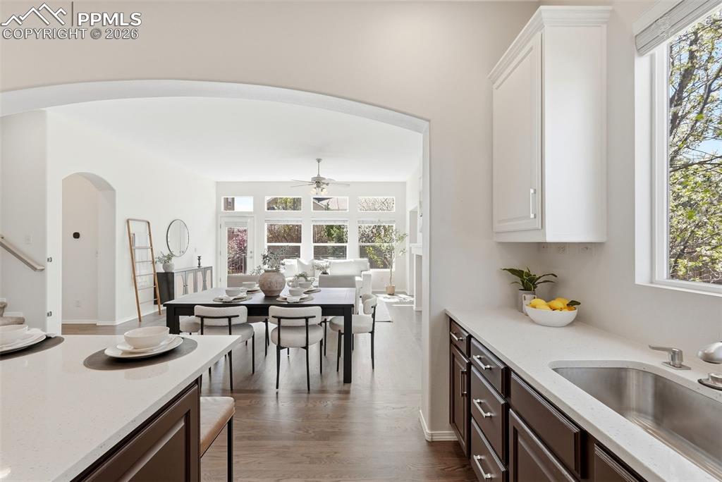 10744 Rhinestone Drive Colorado Springs, CO 80908 - Photo 4 of 50 a kitchen with a sink a stove and chairs