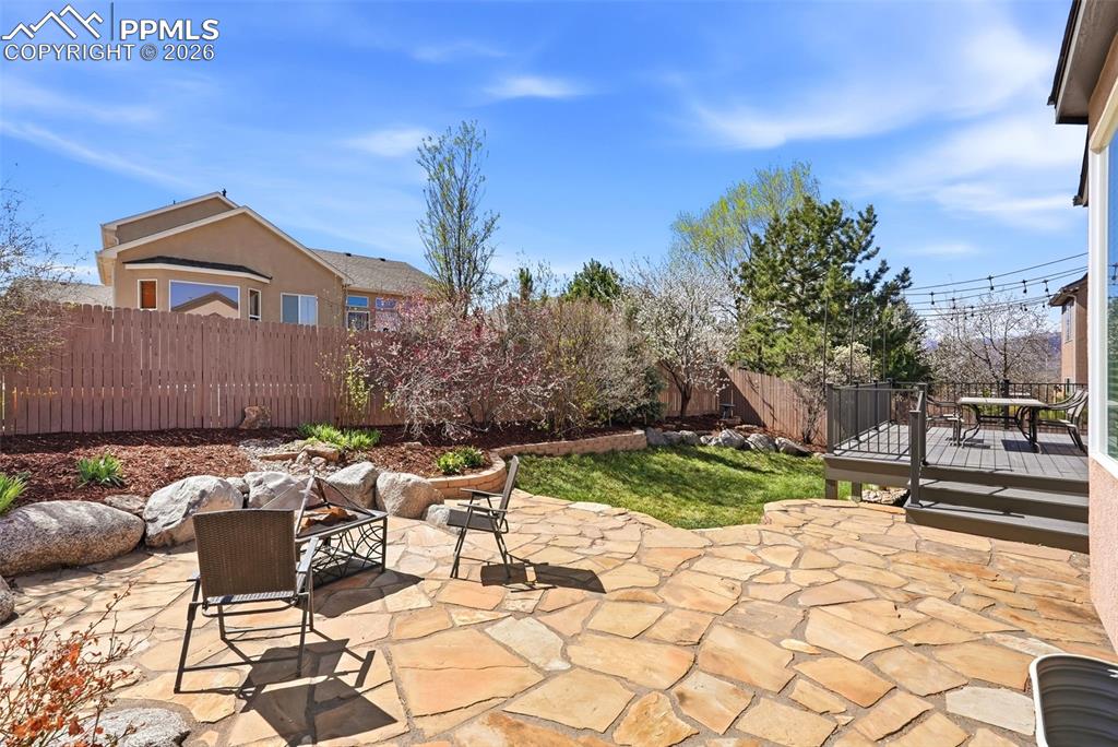10744 Rhinestone Drive Colorado Springs, CO 80908 - Photo 44 of 50 a view of a patio with table and chairs and potted plants