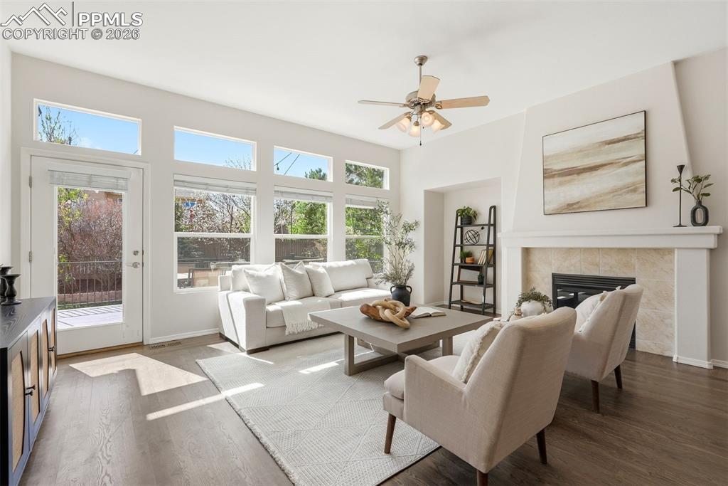 10744 Rhinestone Drive Colorado Springs, CO 80908 - Photo 7 of 50 a living room with furniture a fireplace and a large window
