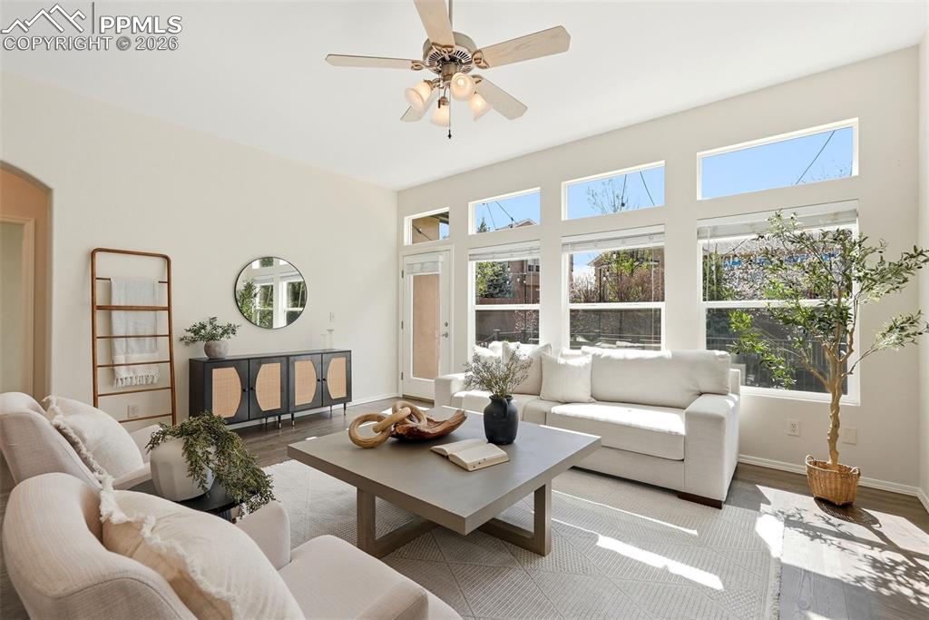 10744 Rhinestone Drive Colorado Springs, CO 80908 - Photo 8 of 50 a living room with furniture a table and a large window