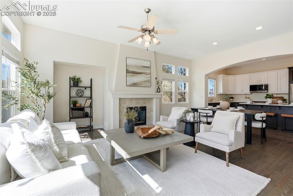10744 Rhinestone Drive Colorado Springs, CO 80908 - Photo 9 of 50 a living room with furniture a fireplace and a chandelier