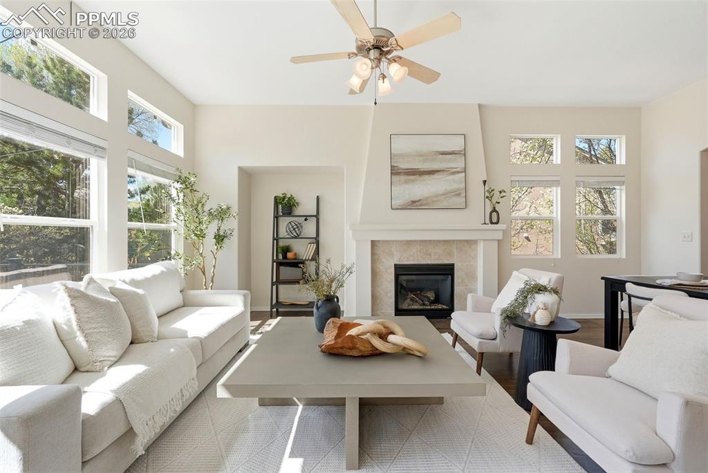 10744 Rhinestone Drive Colorado Springs, CO 80908 - Photo 10 of 50 a living room with furniture a fireplace and a large window