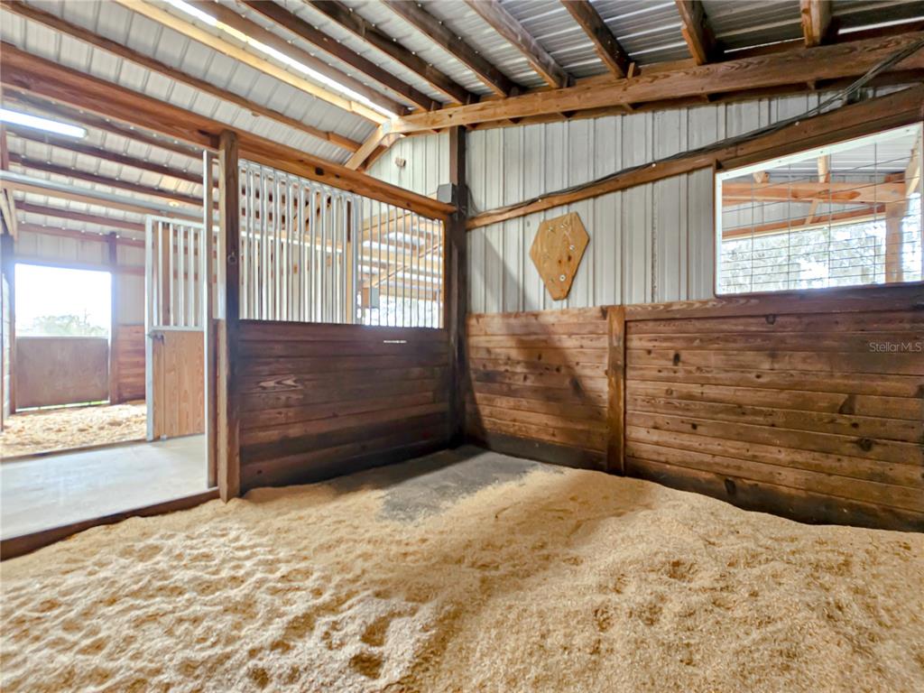 41204 Emeralda Island Road Leesburg, FL 34788 - Photo 16 of 53 a view of a room with a bed and wooden floor
