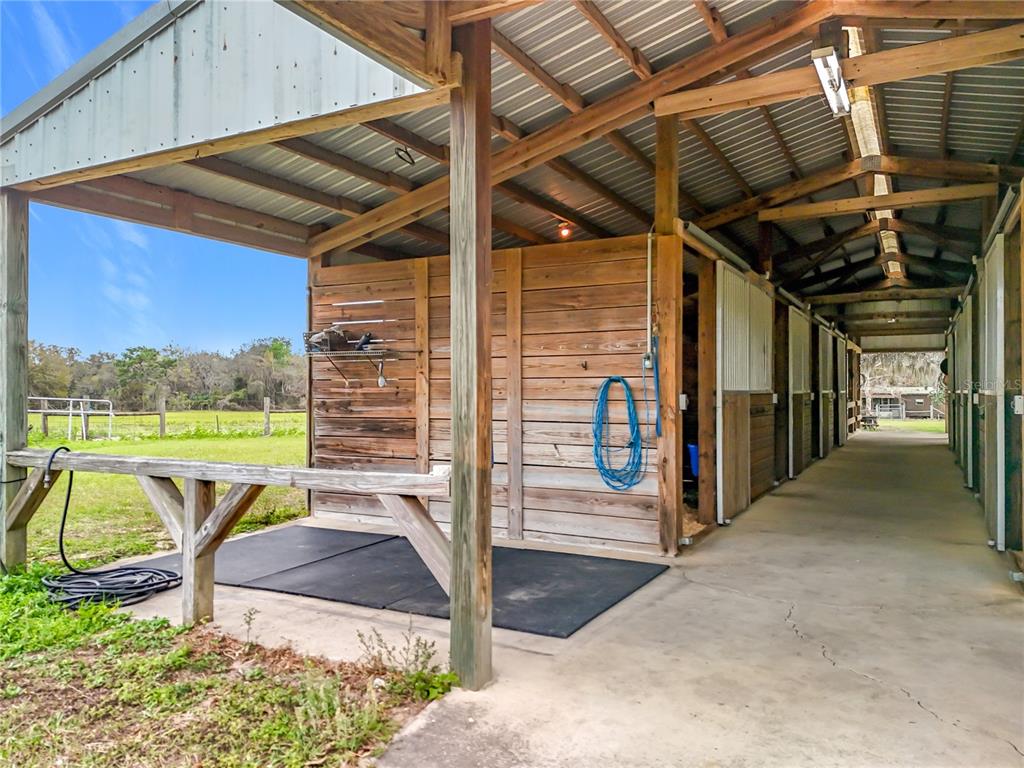 41204 Emeralda Island Road Leesburg, FL 34788 - Photo 24 of 53 a view of a porch with a table and chairs