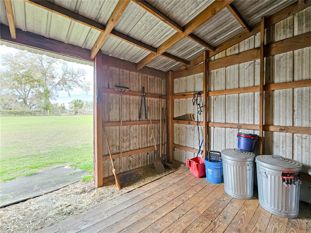 41204 Emeralda Island Road Leesburg, FL 34788 - Photo 28 of 53 a view of a room with wooden floor and iron stairs